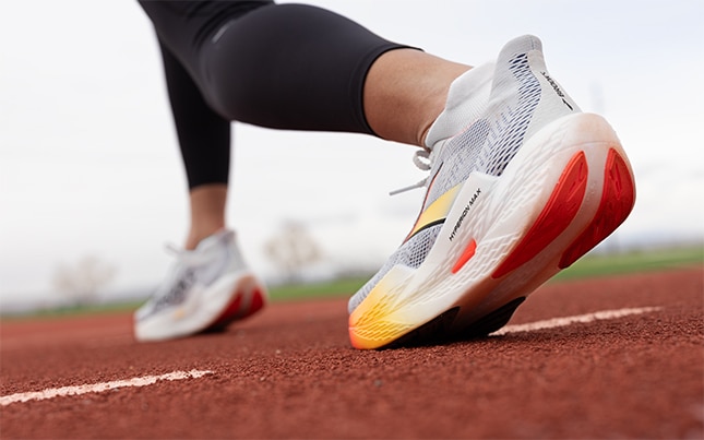 A low-angle shot of a runner pushing off mid-stride.